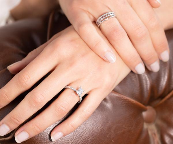 A photo of a woman‘s hands wearing silver rings