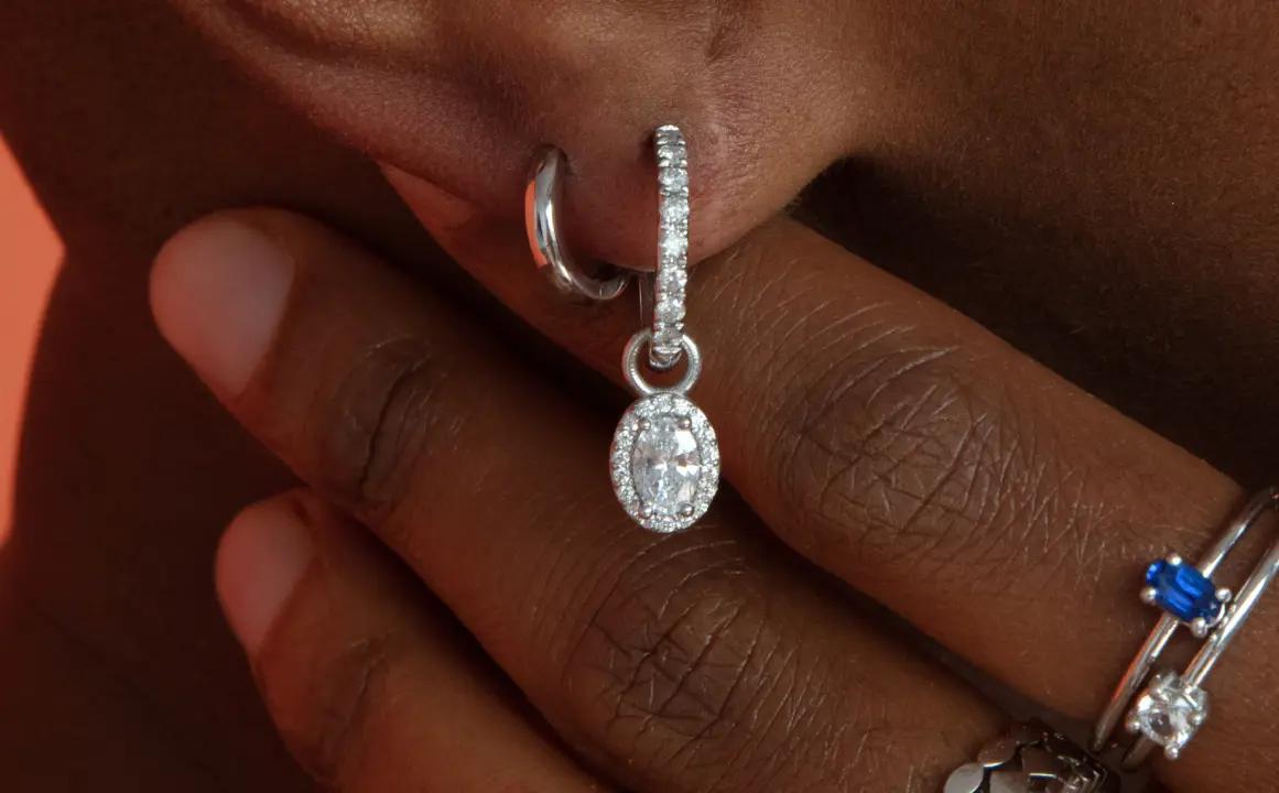 Two earrings are shown, one of them is a 14K White Gold Earring Charms